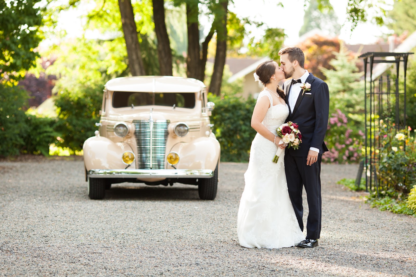 Wedding portrait location at Ainsworth House with late afternoon sun backlighting garden foliage