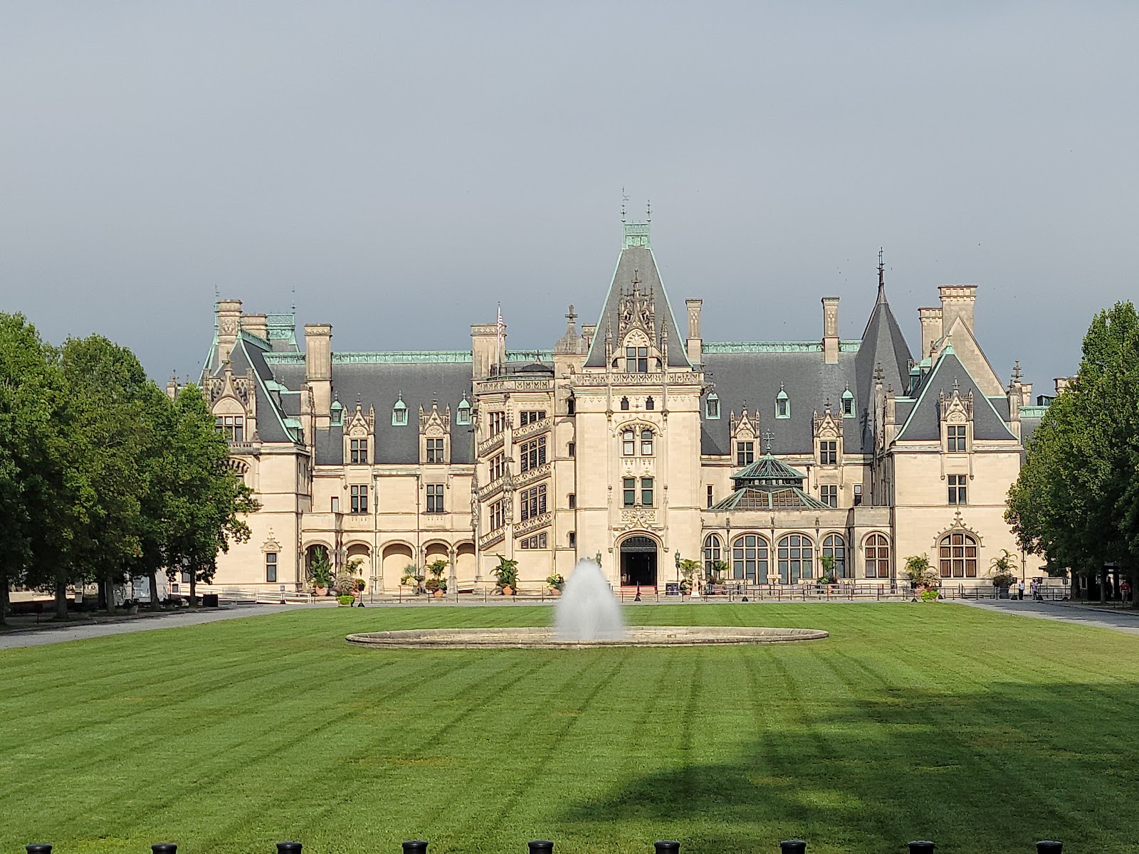 Blue Ridge mountain ridgelines beyond the Biltmore Estate grounds at low sun