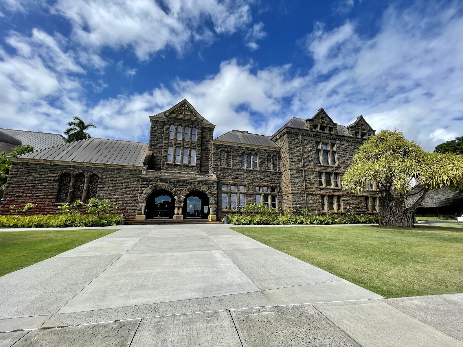 Tall hall panelled in dark koa hardwood with galleried levels