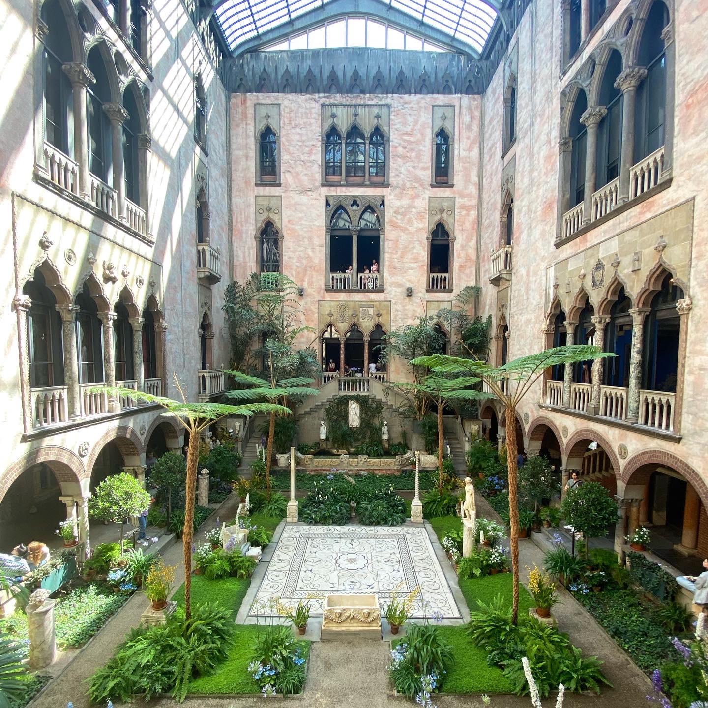 Soft overhead daylight filling the glass-roofed courtyard at the Gardner Museum, Boston