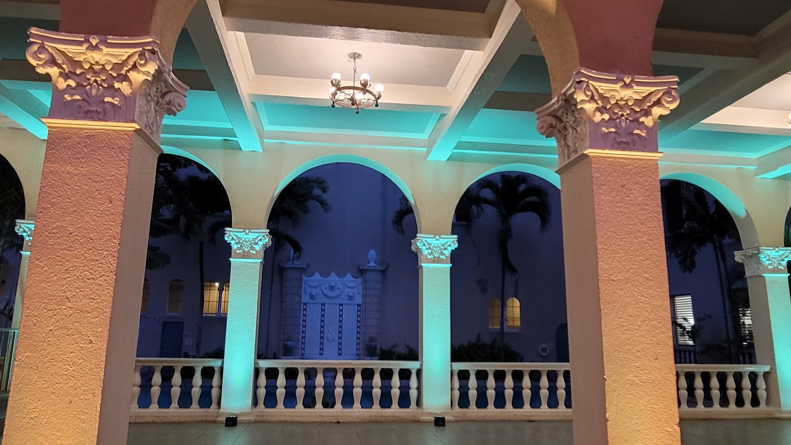 Receding run of arches with bands of light between the columns