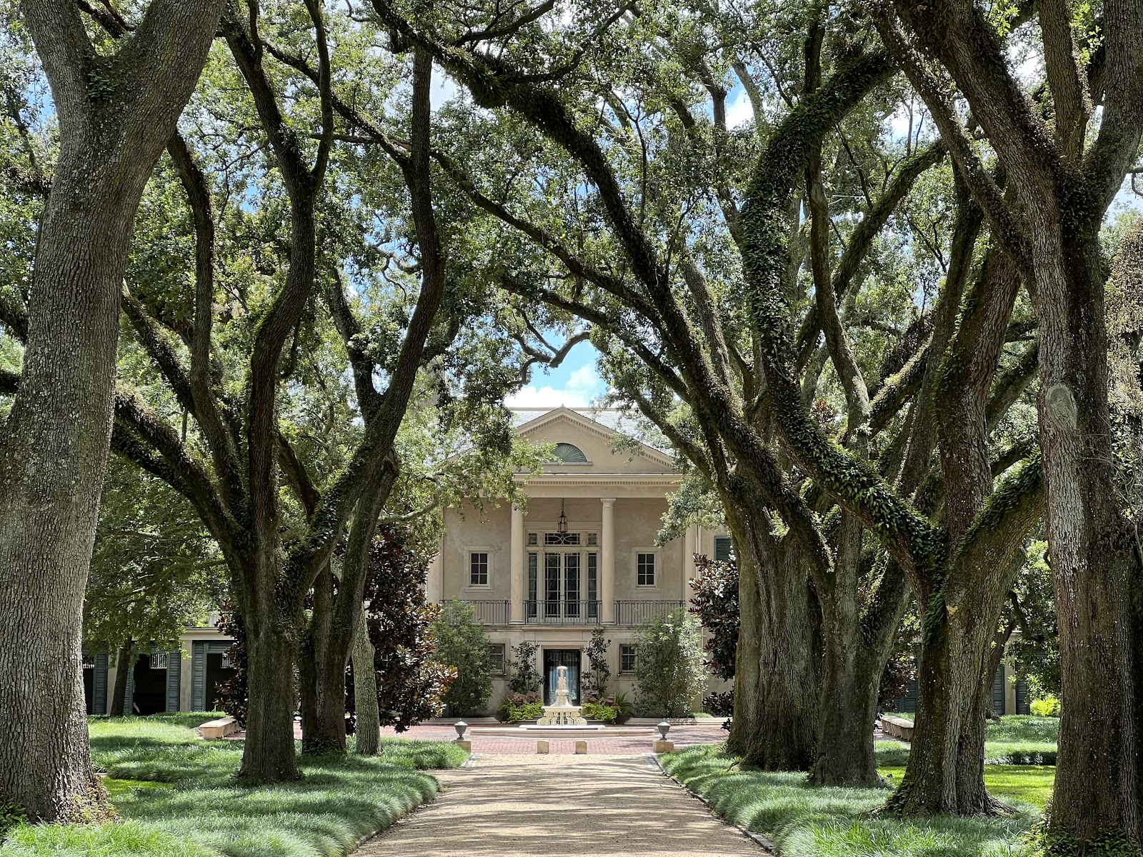 Low evening light raking across formal hedges and paths at Longue Vue, New Orleans