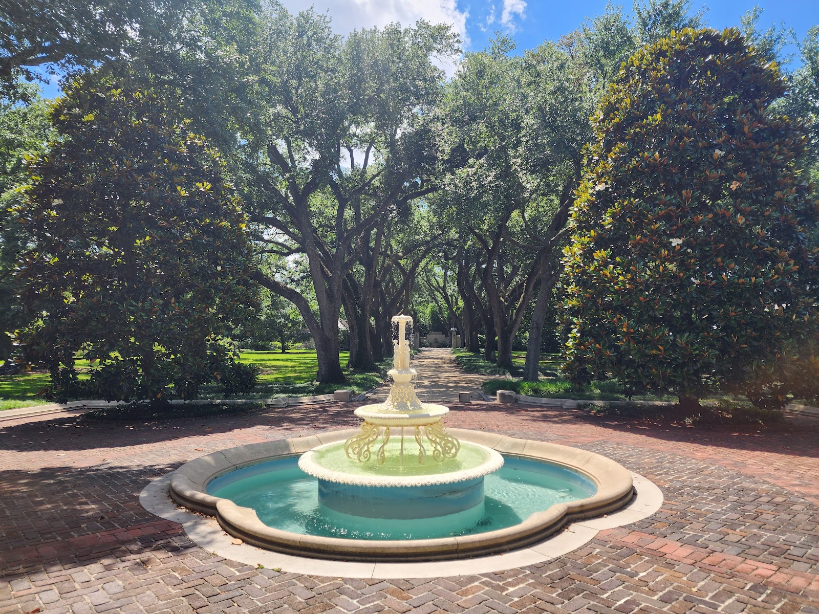 Wet formal planting and darkened stone at Longue Vue gardens after a Louisiana downpour