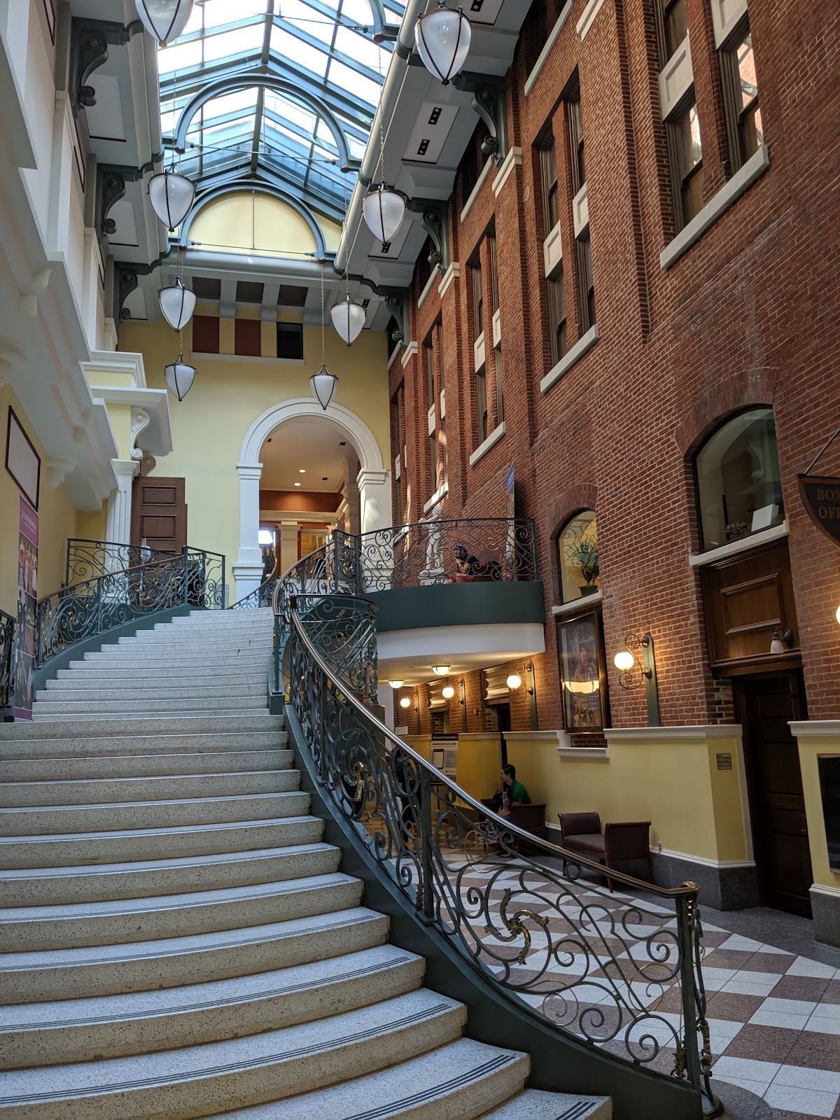 View down through cast-iron balustrades onto the marble floor of the George Peabody Library