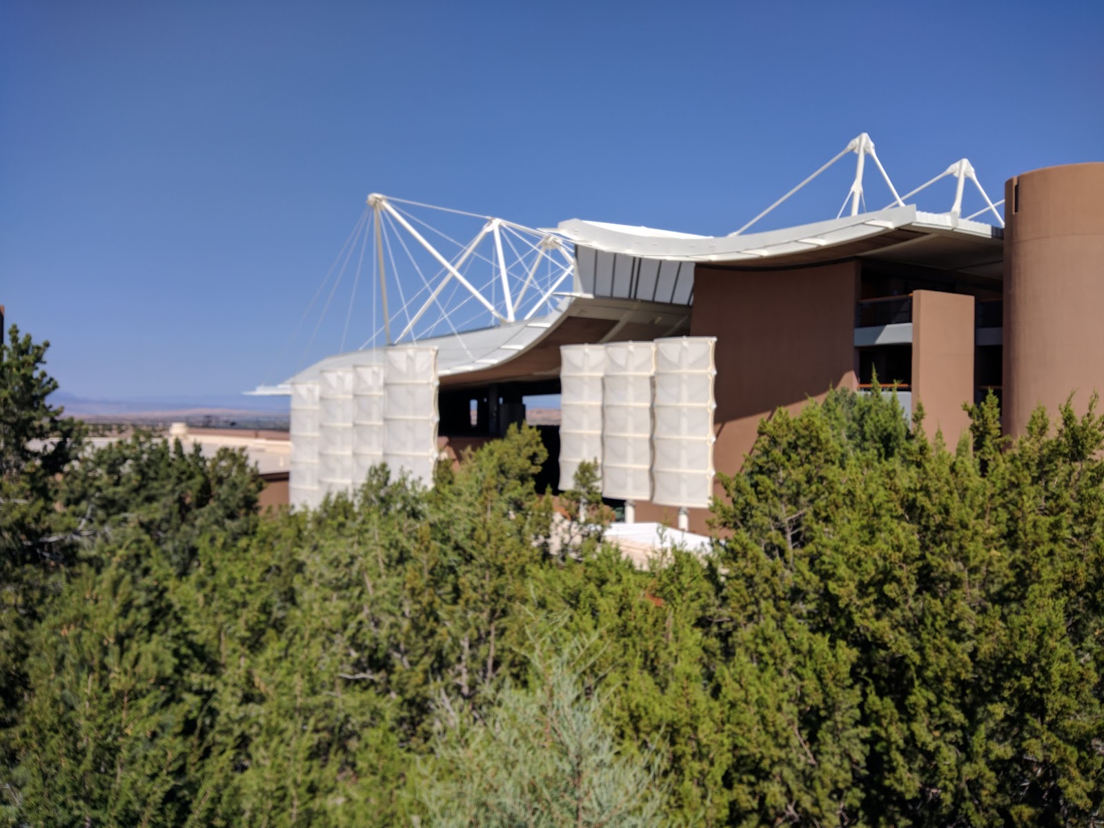 Soft lateral daylight under the roof at the Santa Fe Opera, with mountains beyond