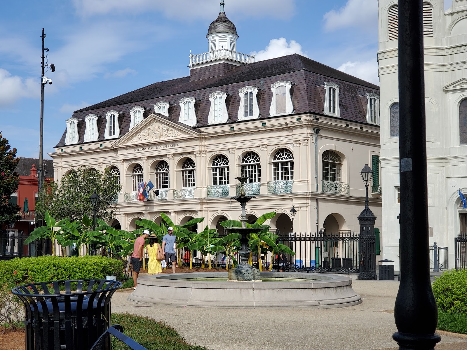 Wedding portrait under the covered arcade at the Cabildo, lit from the open side