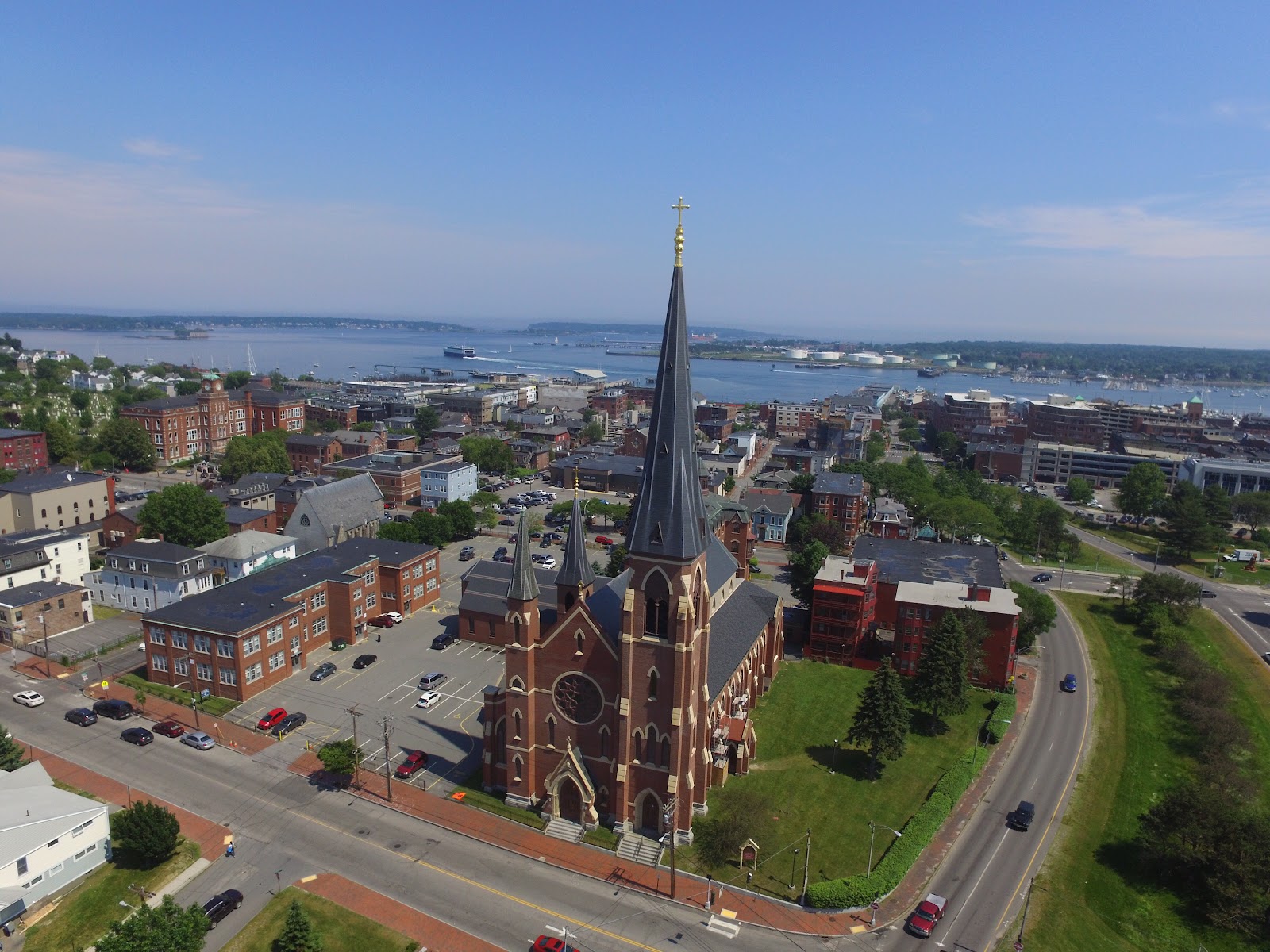 Gothic Revival cathedral massing and tower in low raking light, Portland Maine