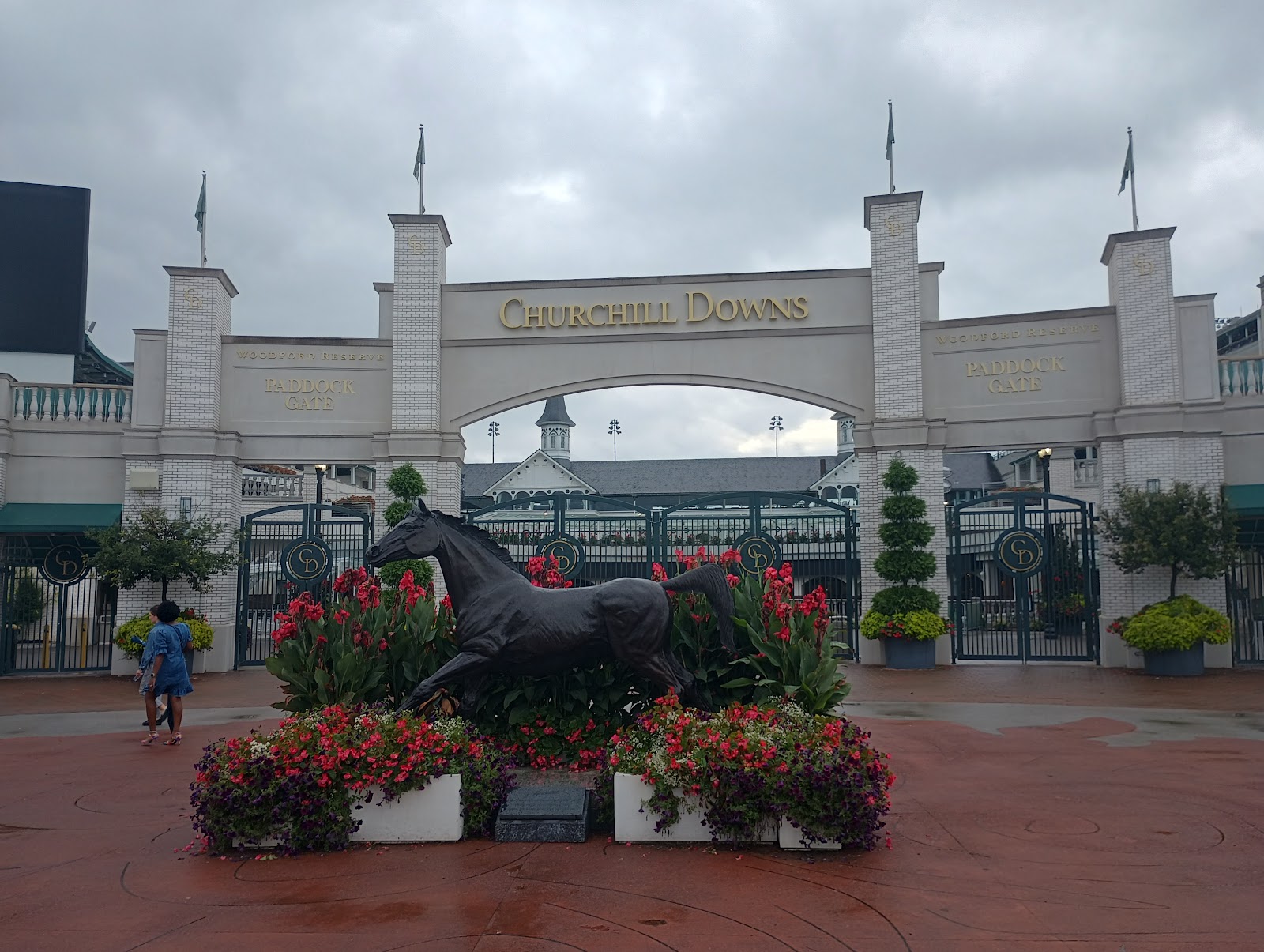 Twin spires of Churchill Downs lit at dusk with colour still in the sky