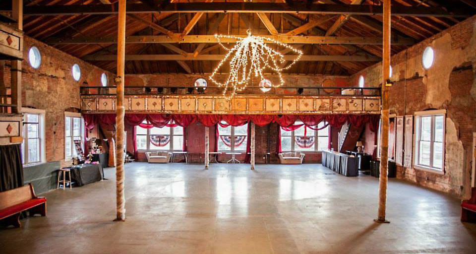Saturated coloured stage lighting washing the Crystal Ballroom interior during a wedding reception
