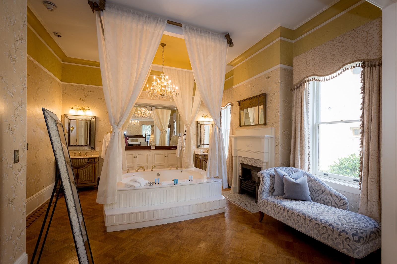 Italianate period room with a tall window at The Gastonian, Savannah Georgia