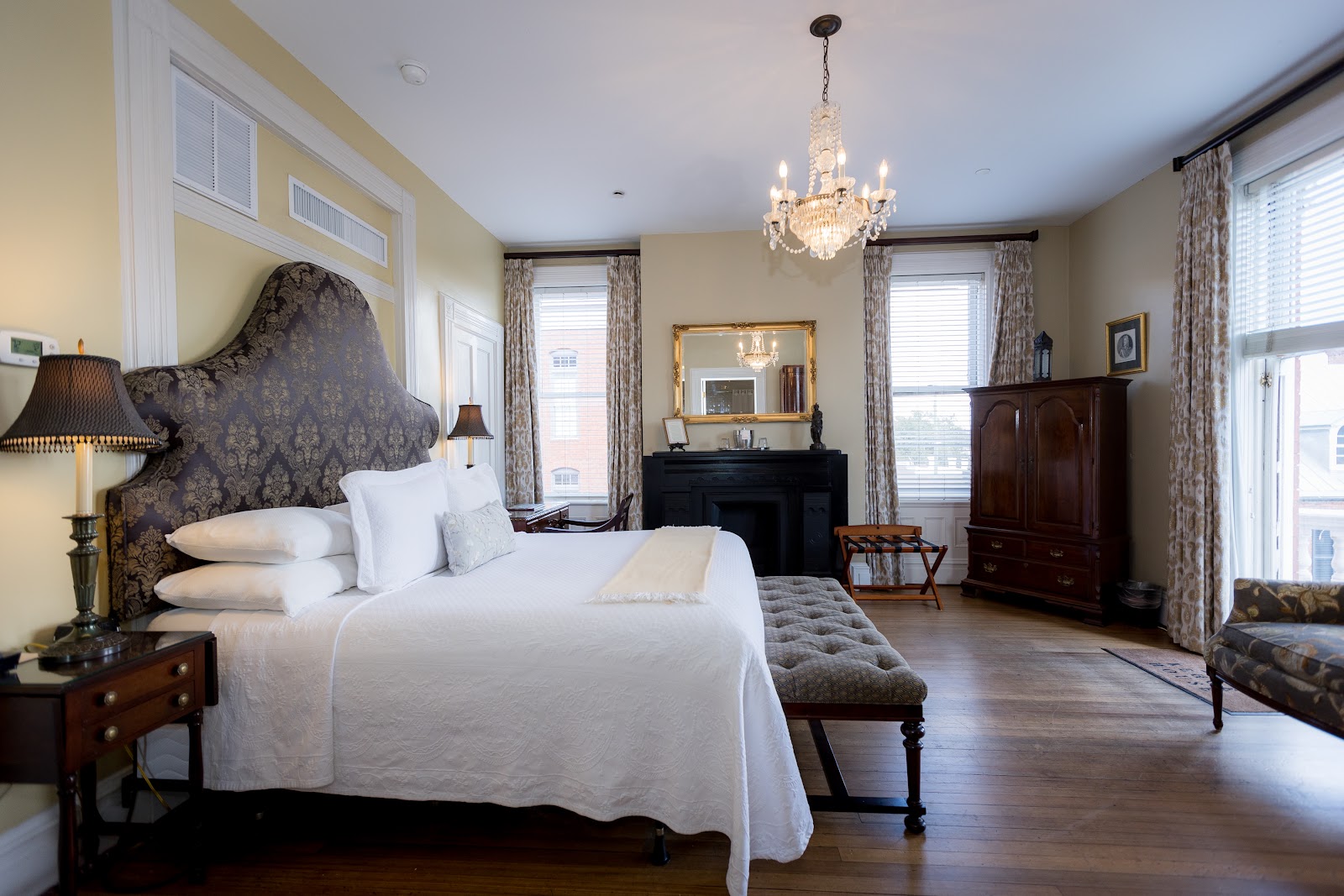 Tall Victorian window giving soft daylight in a guest room at the Kehoe House, Savannah