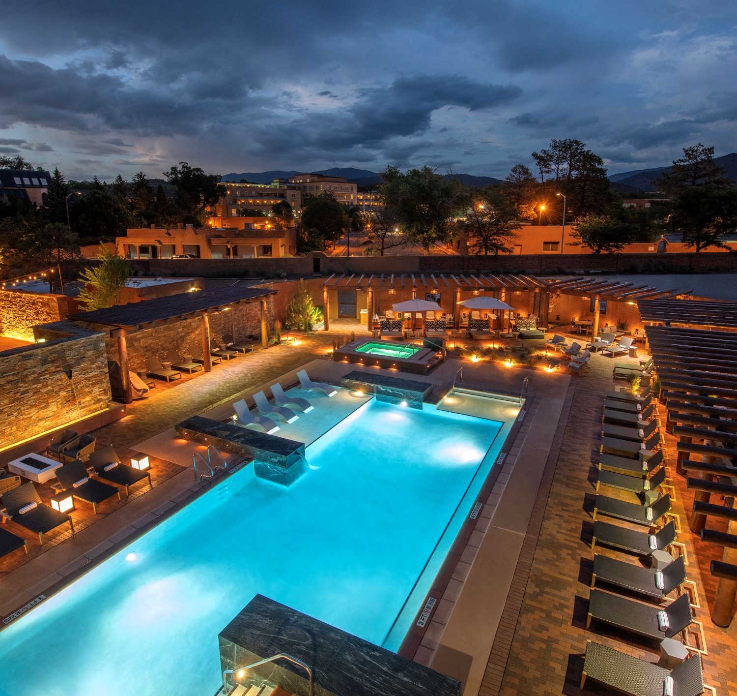 Thick adobe wall with a deep window reveal shaping interior light at the Inn and Spa at Loretto