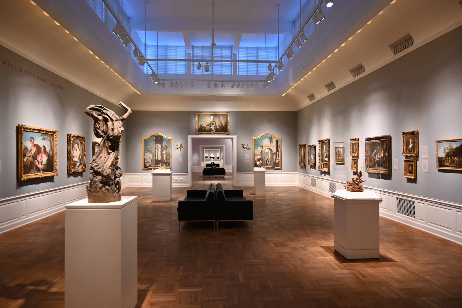 Wide architectural interior at the Portland Art Museum with a wedding couple small in the frame