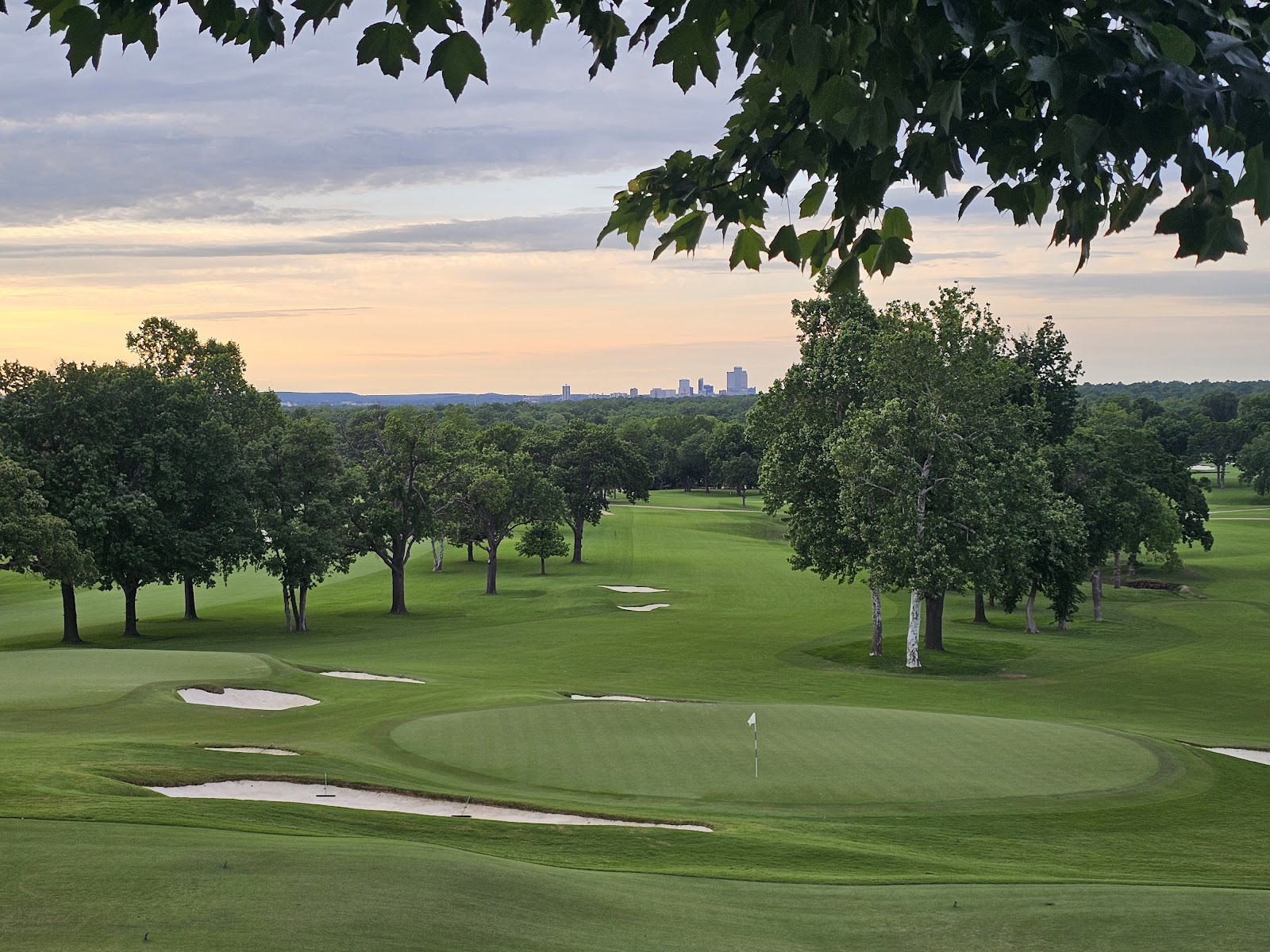 High open shade under a mature specimen tree on the course at Southern Hills, Tulsa