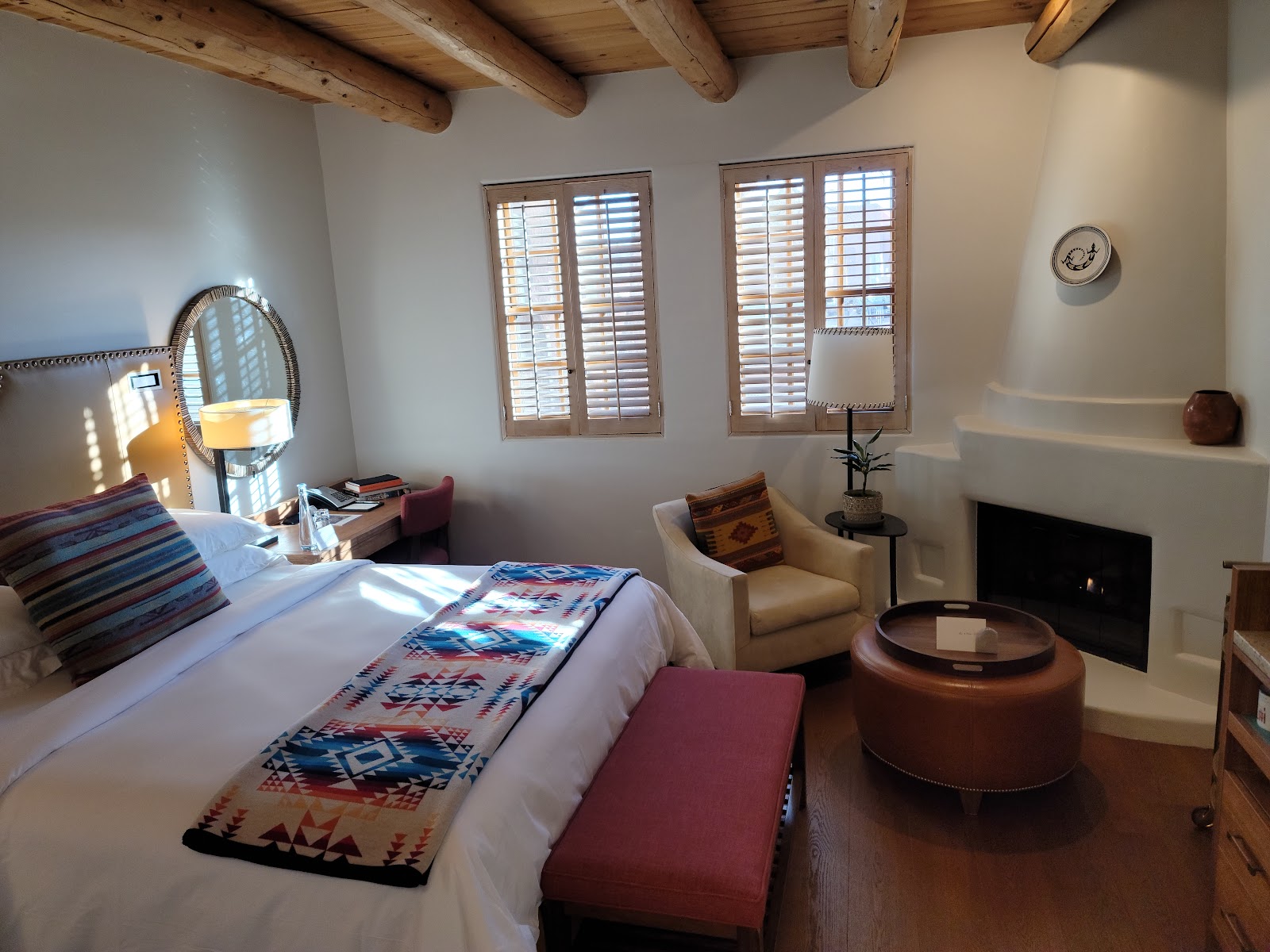 Lit kiva fireplace providing warm flickering light at the Rosewood Inn of the Anasazi, Santa Fe
