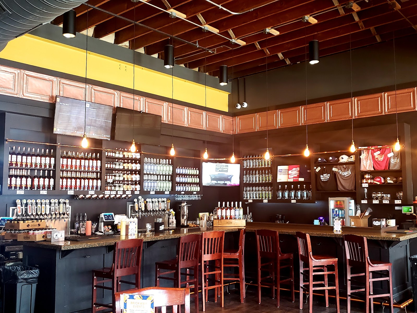 Exposed brick and steel with industrial overhead lighting at The Brickway, Omaha