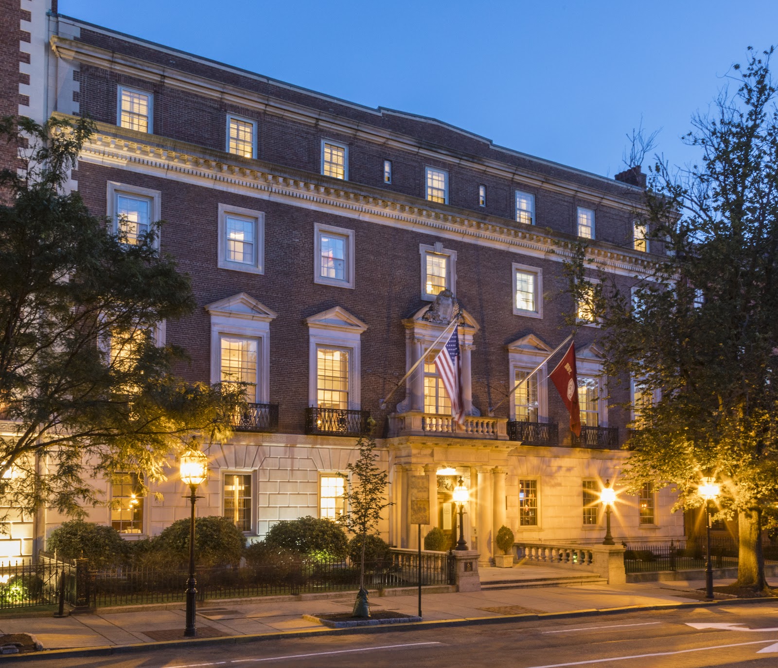 Warm lamplit panelled room at the Harvard Club of Boston set for a wedding dinner