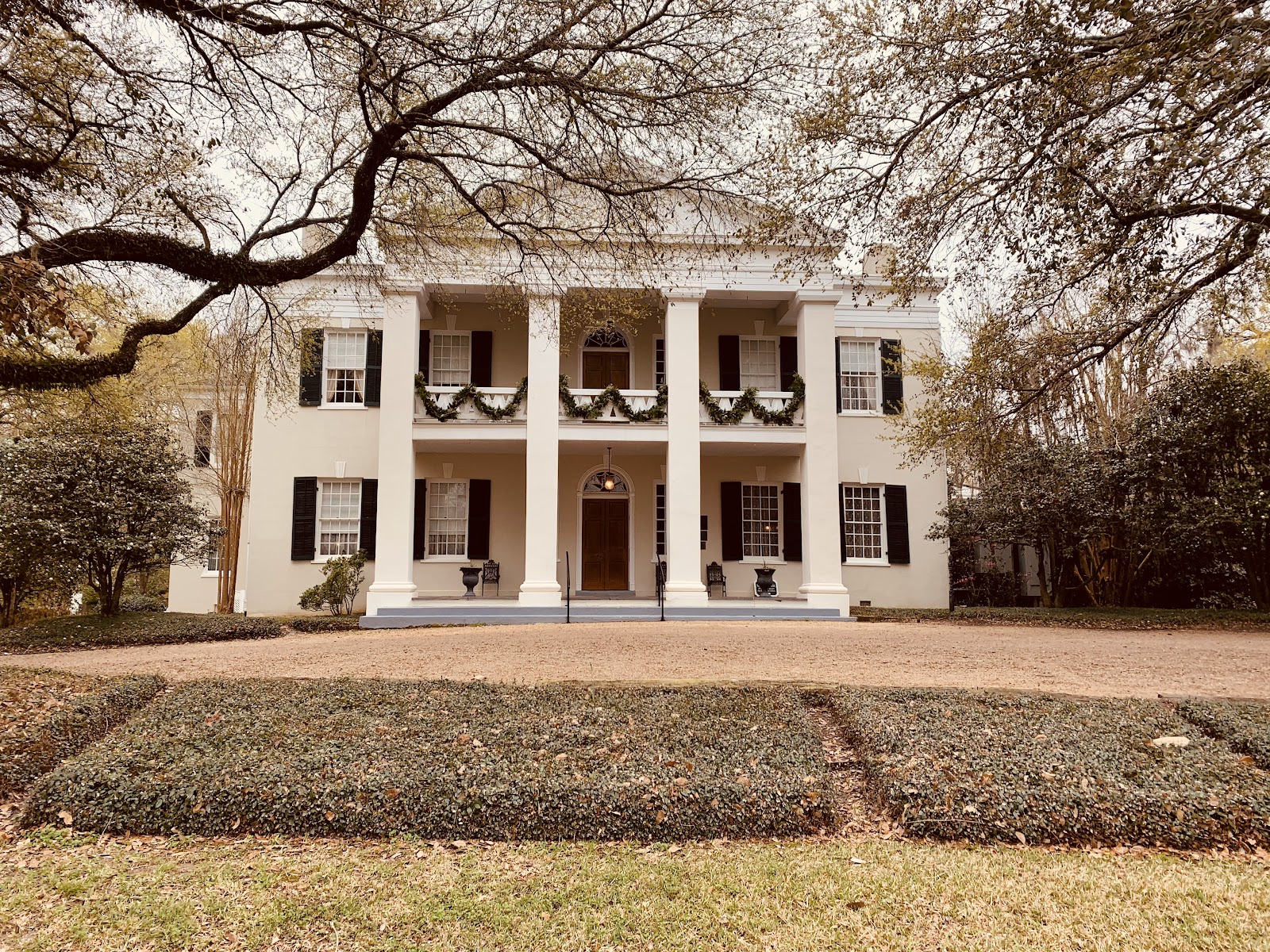 Still water mirroring trees and sky on landscaped Natchez grounds
