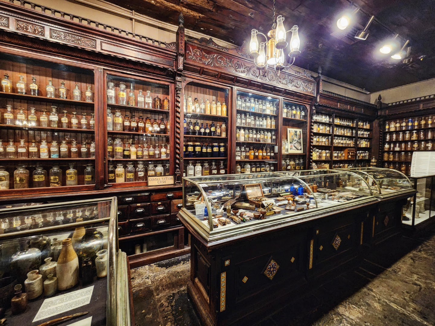 Glass-fronted apothecary cabinets at head height in the New Orleans Pharmacy Museum