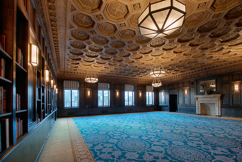 Ornate hotel corridor at the Sentinel Hotel with repeating doors and a window at the far end