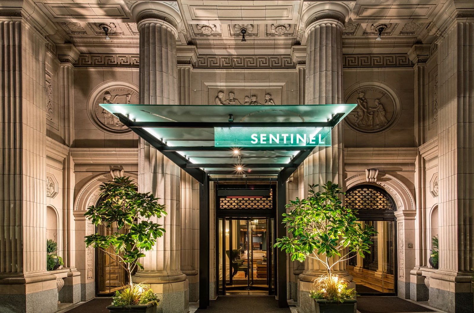 Ornate high-ceilinged historic ballroom with chandeliers at the Sentinel Hotel, Portland