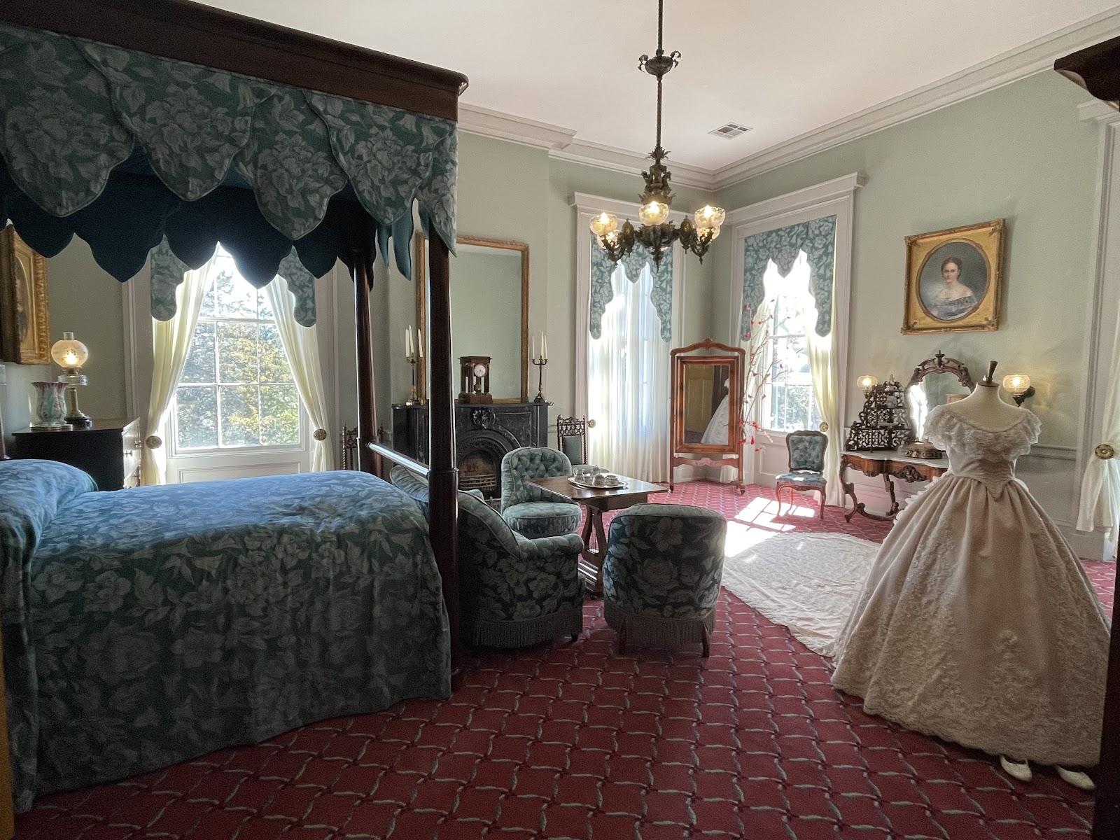 Ornate plaster ceiling and chandelier far brighter than the room below