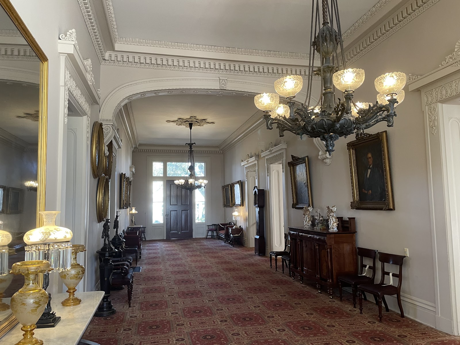 Looking out along a shaded portico with sunlit columns bouncing light in