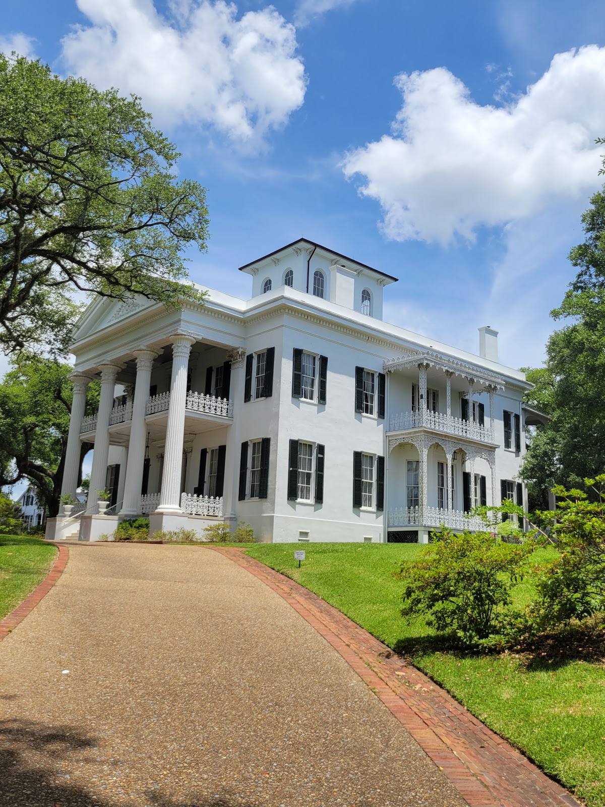 Brightly sunlit white painted columns losing all surface detail