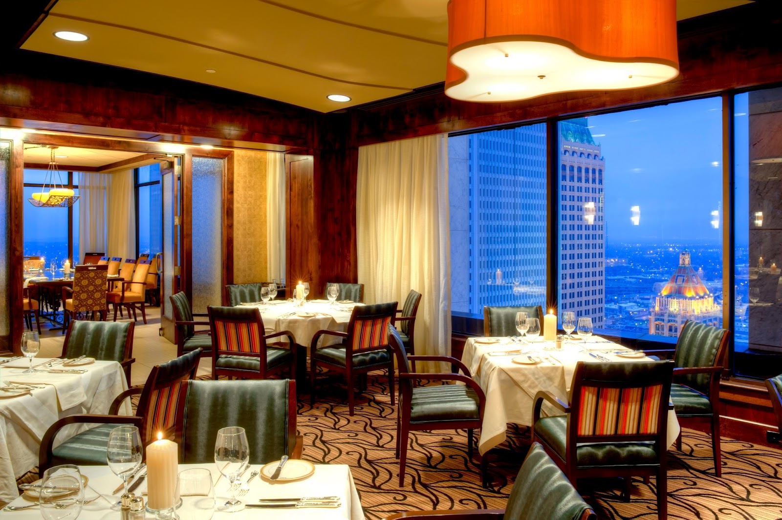 Couple silhouetted against a panoramic city view at The Summit Club, Tulsa