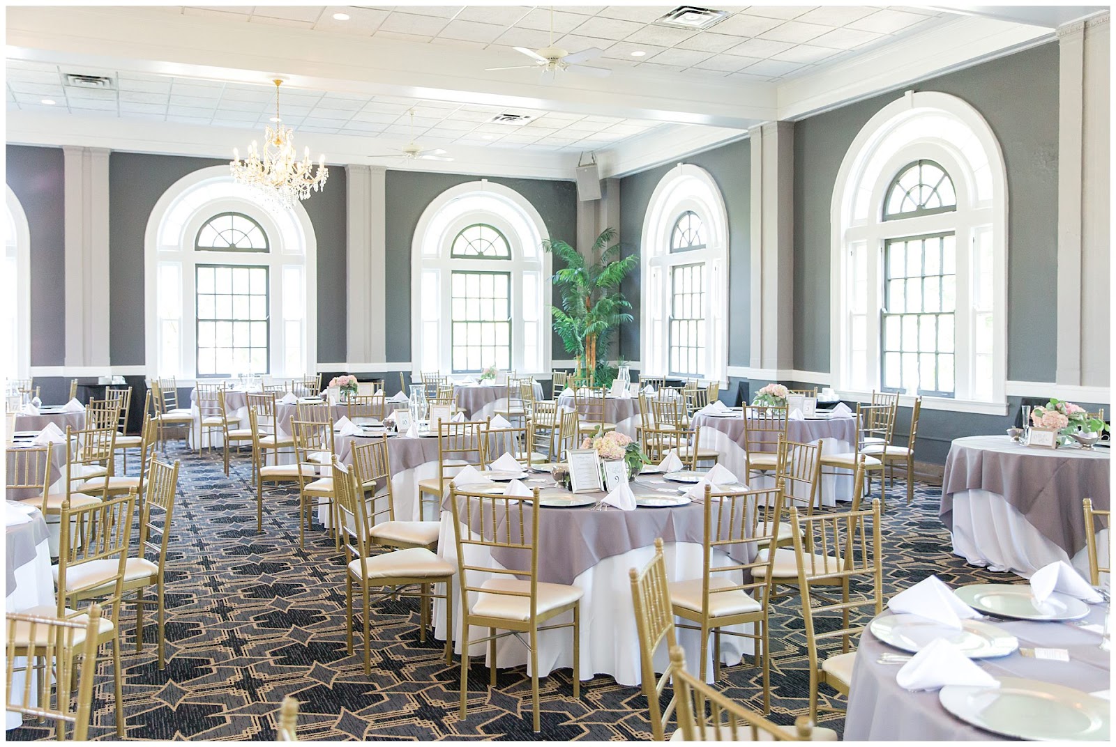 Festoon lighting and uplighting along the barrel vault at a wedding reception in The Olmsted