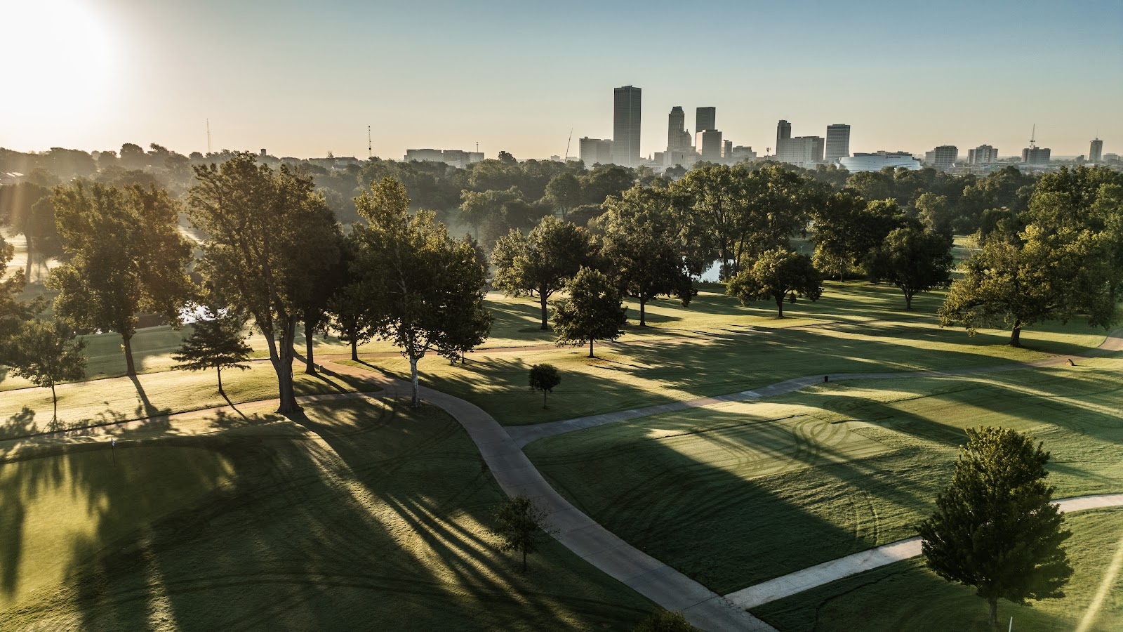 High open shade under a century-old specimen tree at Tulsa Country Club
