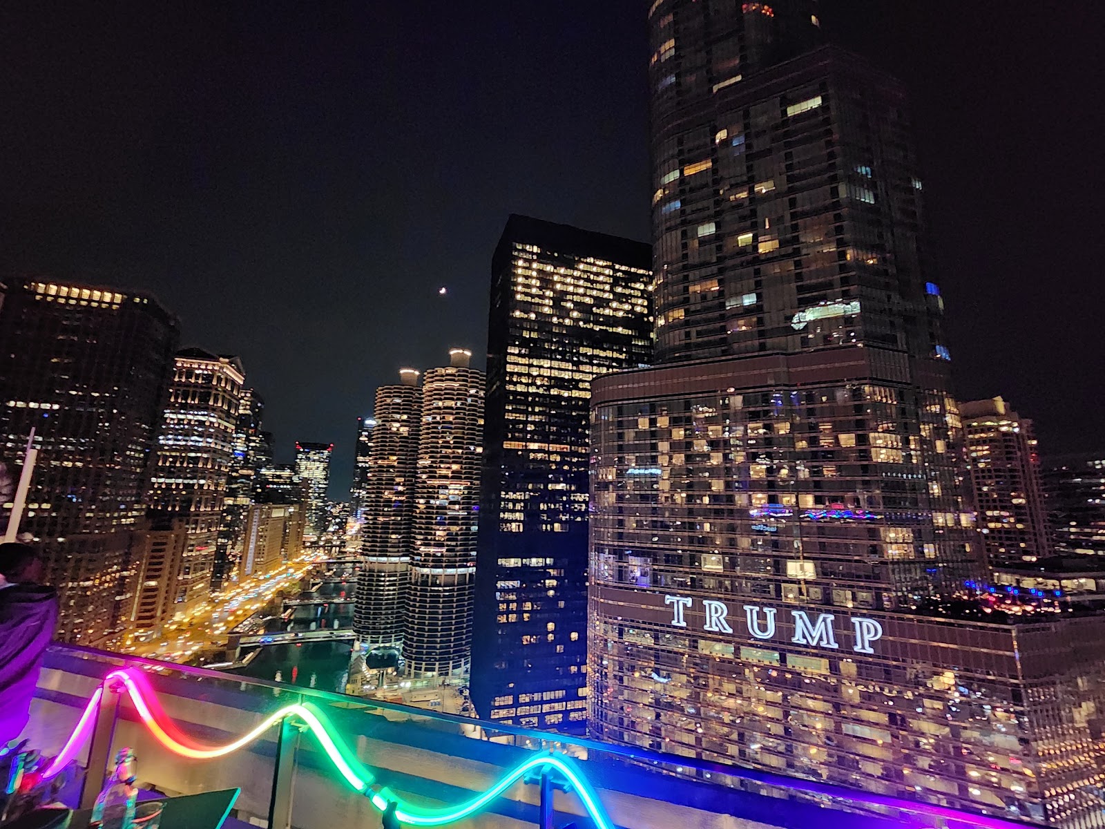 Wind across an exposed rooftop terrace high above a city street