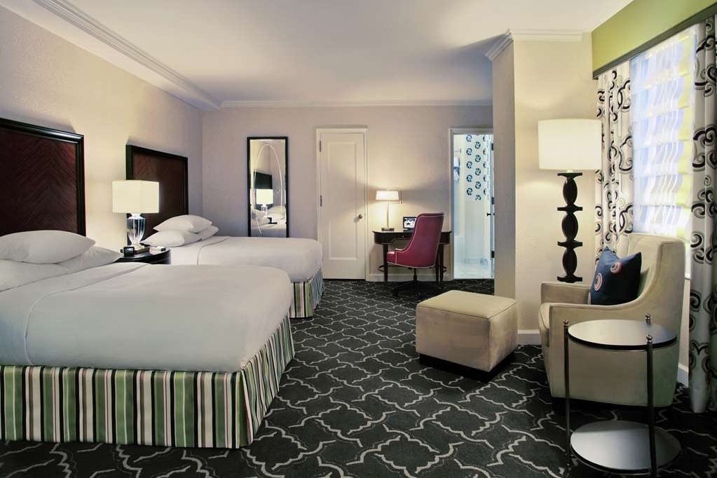 Elevated view across a grand hotel lobby from a staircase landing