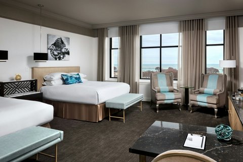 Restrained contemporary hotel guest room with a large window