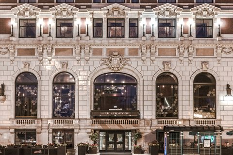 Ornate period public room with plasterwork and chandeliers in a Chicago hotel