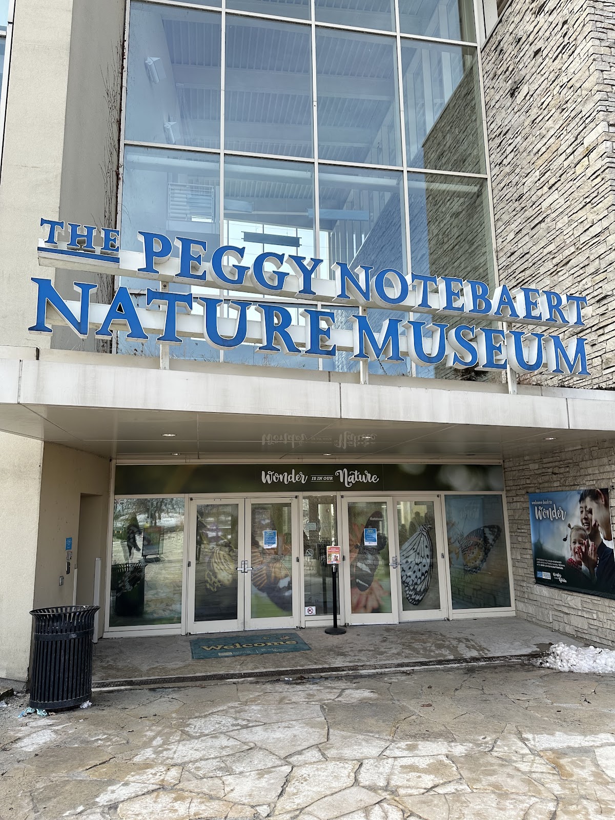 Glass-roofed butterfly haven with dense planting inside, Chicago